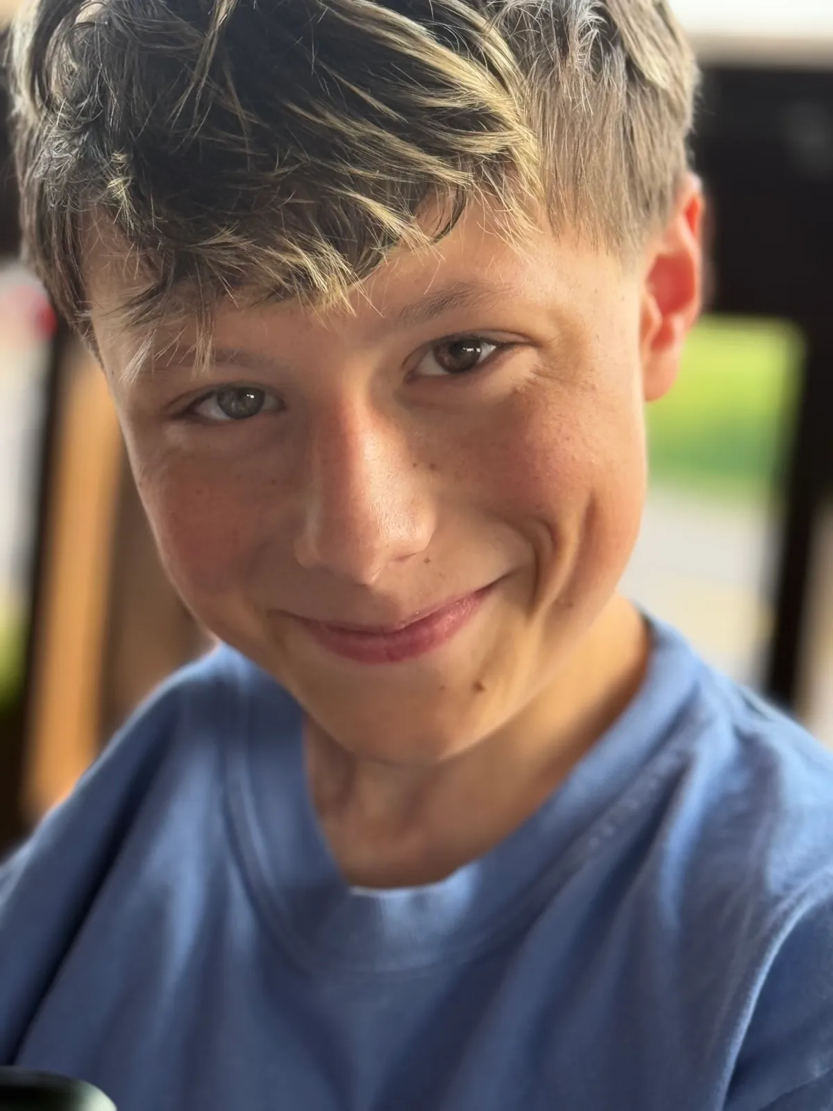 Vhito, smiling, in a blue T-shirt.